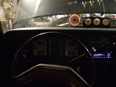 1979 Ford Bronco - The interior of a 1979 Ford Bronco shows a mix of stock dashboard elements and aftermarket gauges.