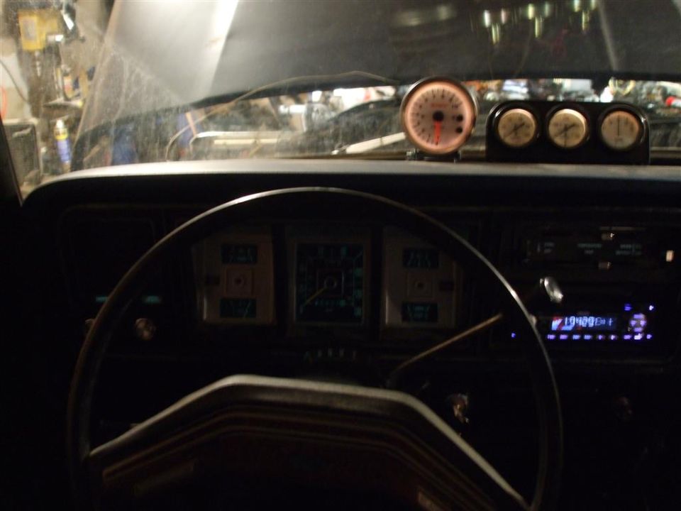 1979 Ford Bronco interior with aftermarket gauges and stock dashboard