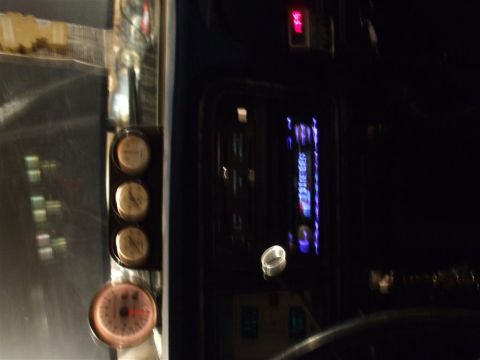 1979 Ford Bronco - Interior view of a vehicle's dashboard, gauges and a stereo system.