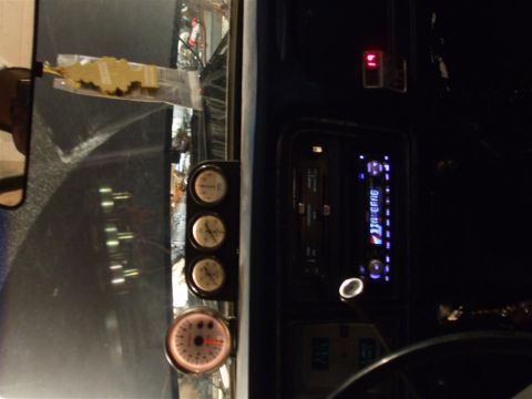 1979 Ford Bronco - Custom gauges and a modern stereo are installed in the vehicle's dashboard.