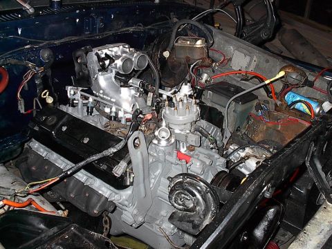 1979 Ford Bronco - Engine bay view of a V8 engine, possibly undergoing modification or repair.