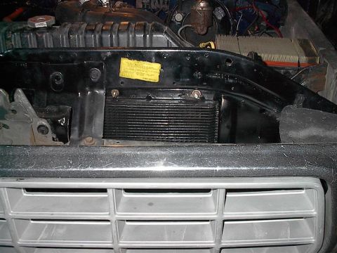1979 Ford Bronco - Close-up of a transmission cooler installed in the engine bay.