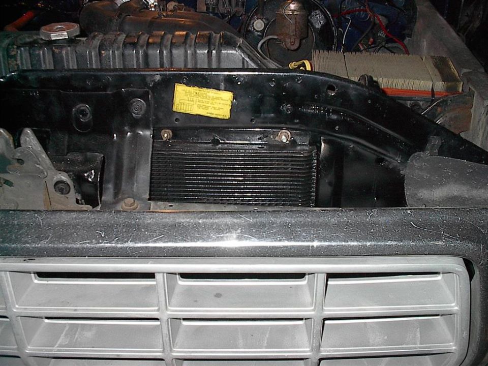 Transmission cooler mounted in front of radiator, with grille visible below