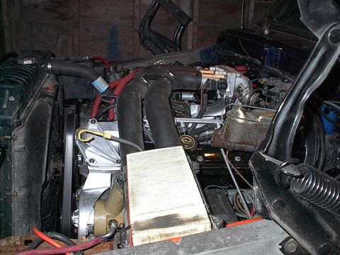 1979 Ford Bronco - The engine bay of a vehicle is shown with various components and hoses visible.