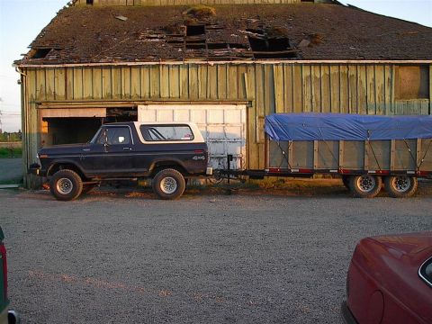 1979 Ford Bronco - This 1979 Ford Bronco is seen from the side, hitched to a trailer in front of an old barn.