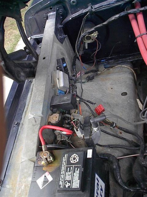 1979 Ford Bronco - Close-up view of the engine bay, showing the battery and electrical system.