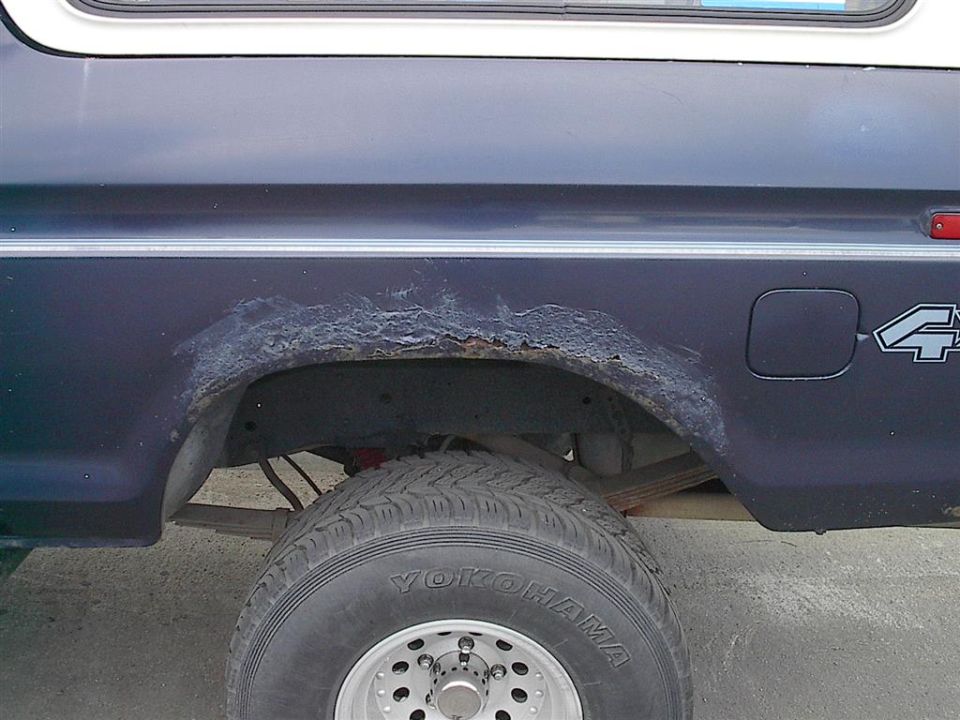 1979 Ford Bronco side view showing rusted rear wheel well and 4x4 decal