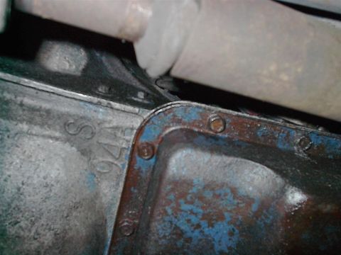 1979 Ford Bronco - Underside view of vehicle components, including stamped markings 'S 176' and part of the exhaust system.