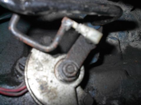1979 Ford Bronco - Throttle linkage mechanism detail, showing rusty metal components and wiring.