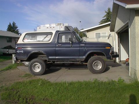1979 Ford Bronco - This classic Ford Bronco is parked on a concrete driveway next to a residential garage.