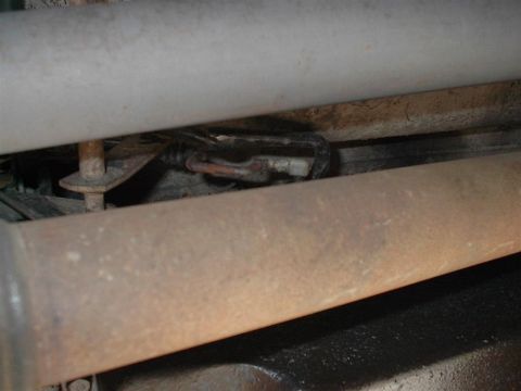 1979 Ford Bronco - Detail of an exhaust pipe and wiring harness, likely from the undercarriage of a vehicle.