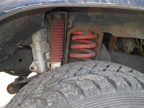 1979 Ford Bronco - This image shows the suspension system of a vehicle, focusing on the coil spring and shock absorber.