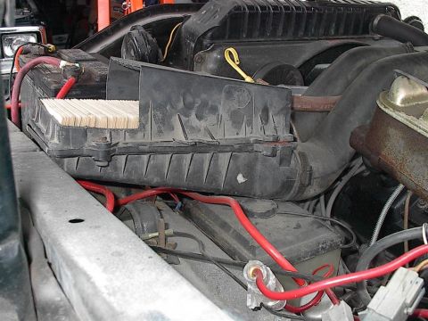 1979 Ford Bronco - The engine bay shows a battery, air filter housing, and various hoses and wiring.