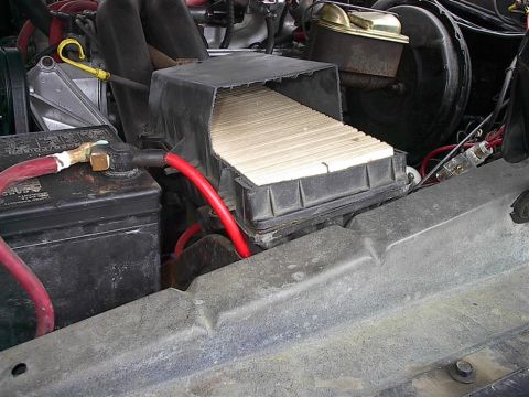 1979 Ford Bronco - Close-up of an engine bay, focusing on the air filter housing and battery.