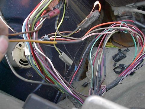 1979 Ford Bronco - A complex vehicle wiring harness is visible, with numerous wires and connectors in disarray.