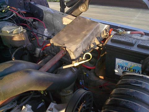 1979 Ford Bronco - Close-up of a vehicle's engine bay, focusing on the battery and electrical components.