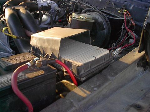 1979 Ford Bronco - The engine bay shows a battery, air filter housing, and various electrical connections.