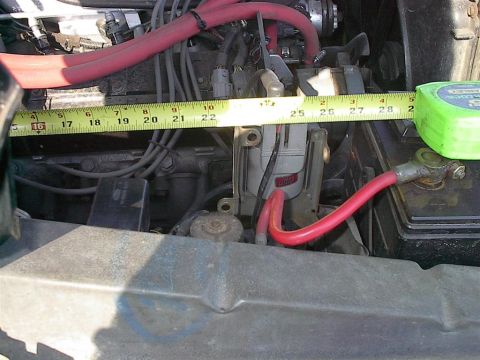 1979 Ford Bronco - A measuring tape is placed across engine components, showing a section of the engine bay.