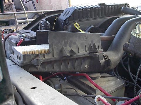 1979 Ford Bronco - A close-up view of a vehicle's engine bay reveals the air filter assembly and radiator.