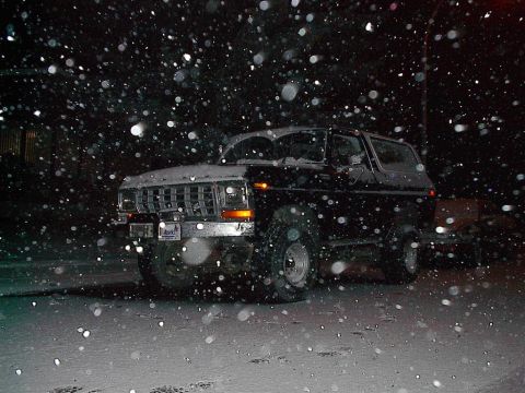1979 Ford Bronco - A black 1979 Ford Bronco sits in the snow during a winter night.