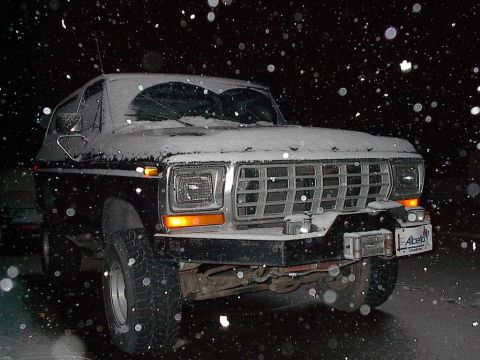 1979 Ford Bronco - Ford Bronco parked outside during a snowfall at night.