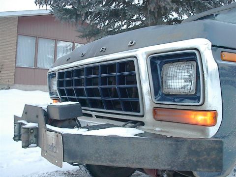 1979 Ford Bronco - Front view of a 1979 Ford Bronco, showing its distinctive grille and bumper in a snowy setting.