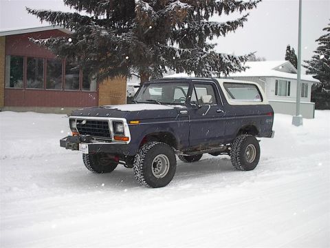 1979 Ford Bronco - A dark blue 1978 Ford Bronco sits in a snowy landscape, its lifted suspension and large tires ready for winter conditions.