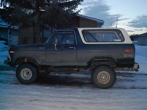1979 Ford Bronco - This 1979 Ford Bronco is shown from the side, parked outdoors in a snowy environment.