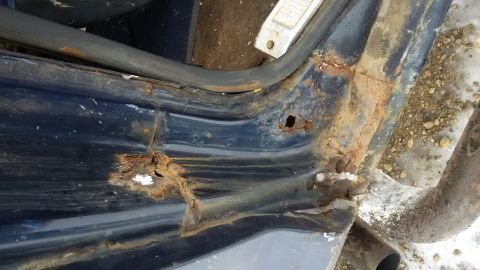 1979 Ford Bronco - Severe rust damage is visible on the door frame and rocker panel of this vehicle.
