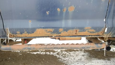 1979 Ford Bronco - This vehicle's lower body panels and running board show significant rust and are covered in icicles, suggesting exposure to harsh winter co…