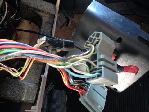 1993 Ford Bronco - Close-up of a vehicle's interior wiring harness, showing numerous colored wires and connectors.