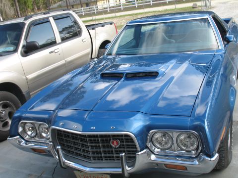 1972 Ford Ranchero - A blue 1972 Ford Ranchero is parked next to a silver SUV.