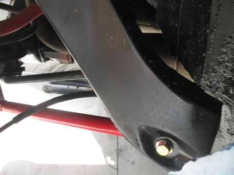 1972 Ford Ranchero - Detail of a vehicle's undercarriage suspension system, showing a painted metal part.