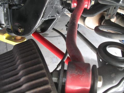 1972 Ford Ranchero - Aftermarket suspension parts, including a red sway bar, are visible in this close-up shot.