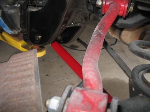 1972 Ford Ranchero - This image shows aftermarket red suspension components and a coil spring, likely from a vehicle's rear axle.