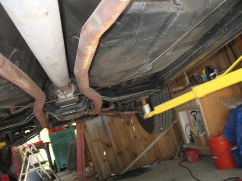 1972 Ford Ranchero - The underside of a vehicle is viewed from below, with the exhaust system and drive shaft clearly visible.