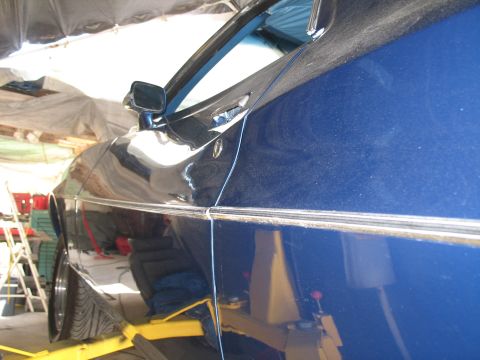 1972 Ford Ranchero - The side profile of a blue 1972 Ford Ranchero is visible on a car lift.