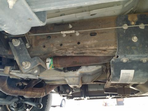 2001 Ford Excursion - The underside of a 2001 Ford Excursion reveals its drivetrain components and chassis structure.