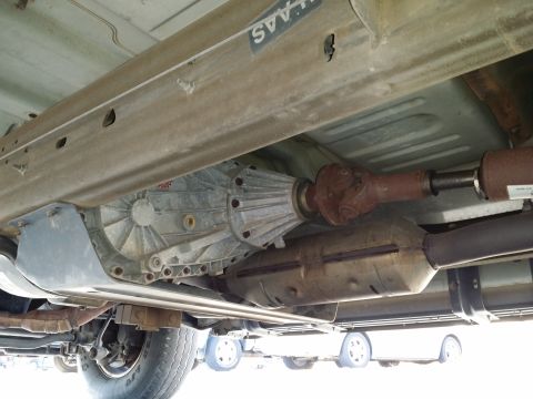 2001 Ford Excursion - Underside view shows the transmission, driveshaft, and exhaust components of a vehicle.