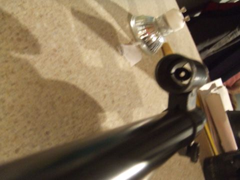 1996 Ford Bronco - A close-up view of a black vehicle component, with a light bulb visible in the background.