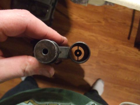 1996 Ford Bronco - A person holds a metal automotive part with two distinct openings for inspection.