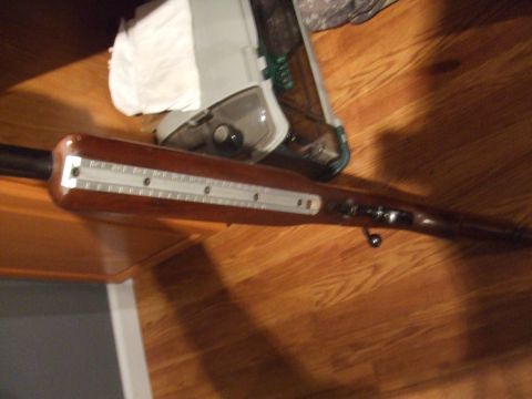 1996 Ford Bronco - Wooden rifle stock with a silver scope mount rail.