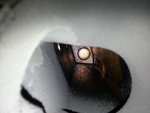1995 Ford Bronco - A close-up view of an engine component, possibly a valve or piston head, with visible wear and a central fastener.