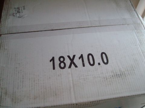 2004 Ford Crown Victoria - A cardboard box displays "18X10.0" indicating wheel size, likely for a vehicle part.
