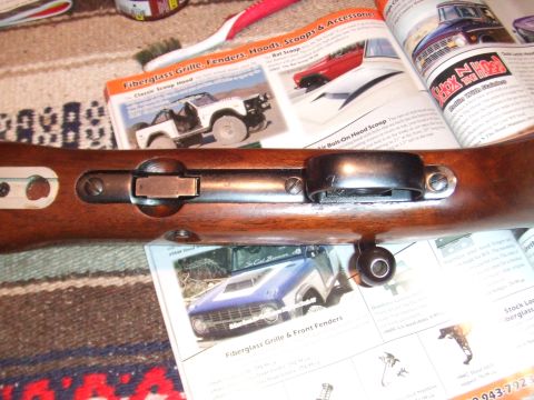 1996 Ford Bronco - Magazines vehicle parts and classic trucks are visible beneath a rifle's wooden stock.