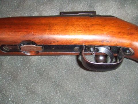 1996 Ford Bronco - Detail view of the trigger assembly and wooden stock of a firearm.