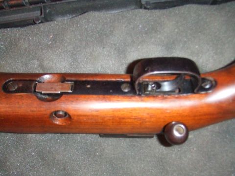 1996 Ford Bronco - Detail of a firearm's trigger assembly and wooden stock.