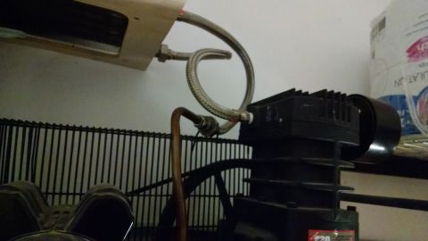 1995 Ford Bronco - Close-up of an air compressor pump, showing its mechanical components and connections.