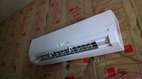 1995 Ford Bronco - Wall-mounted air conditioner unit installed on an insulated wall.