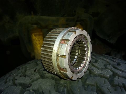 1981 Ford Bronco - Close-up of a Warn hub part resting on a tire.